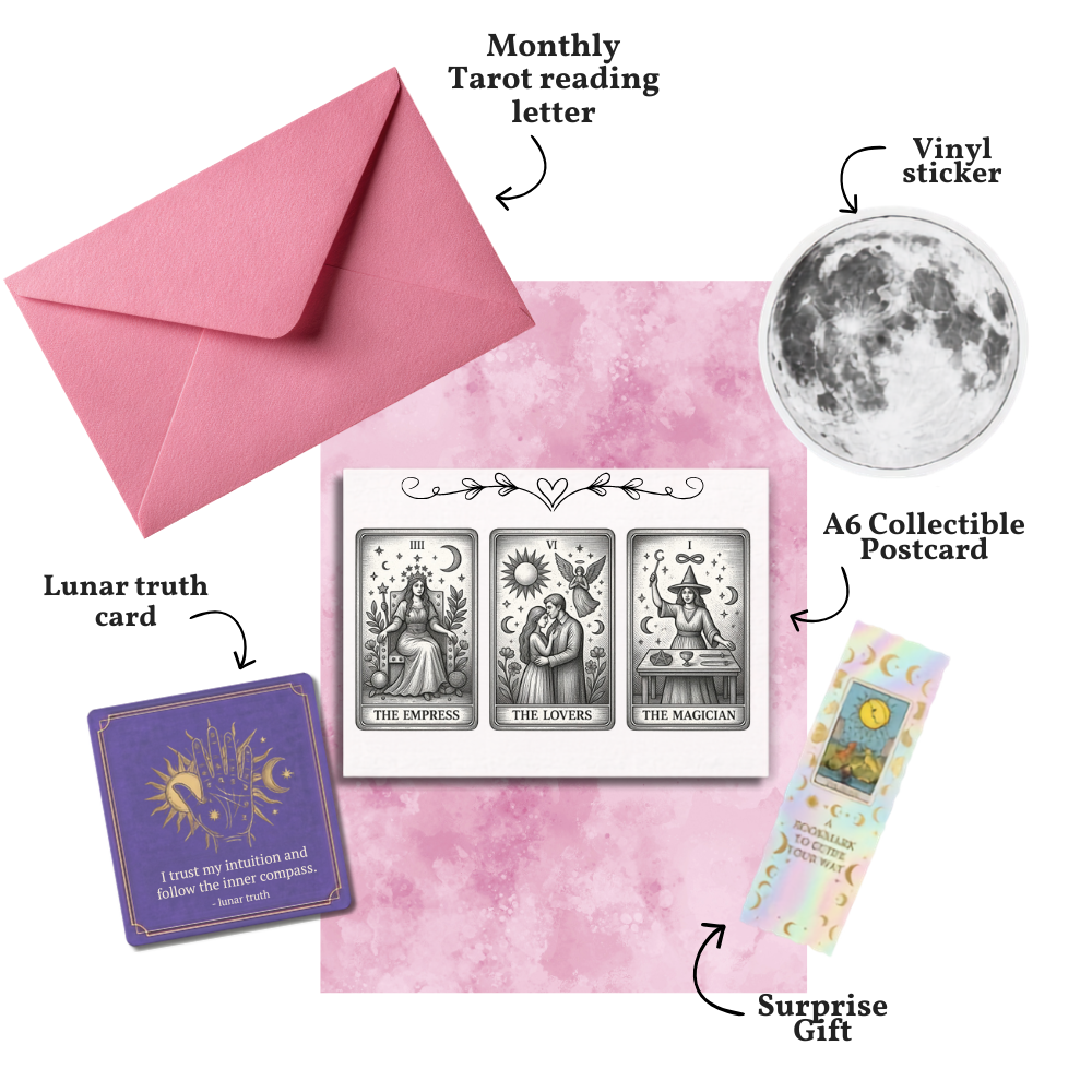 Collection of tarot cards, envelope, and other items on a pink background